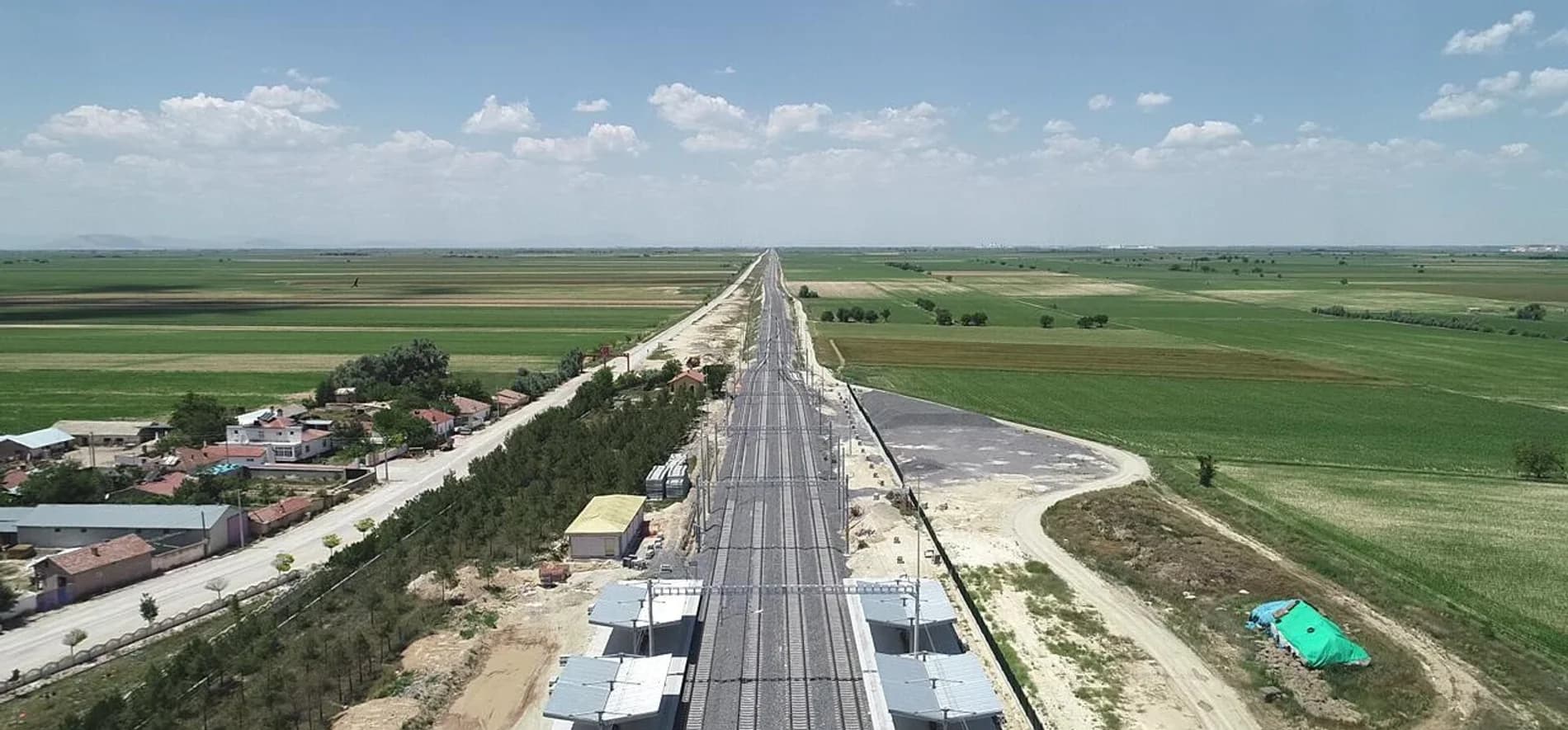 Aerial view of the completed Suduragi-Ayranci high-speed railway line running through farmland, part of a completed Gokbilge infrastructure project.