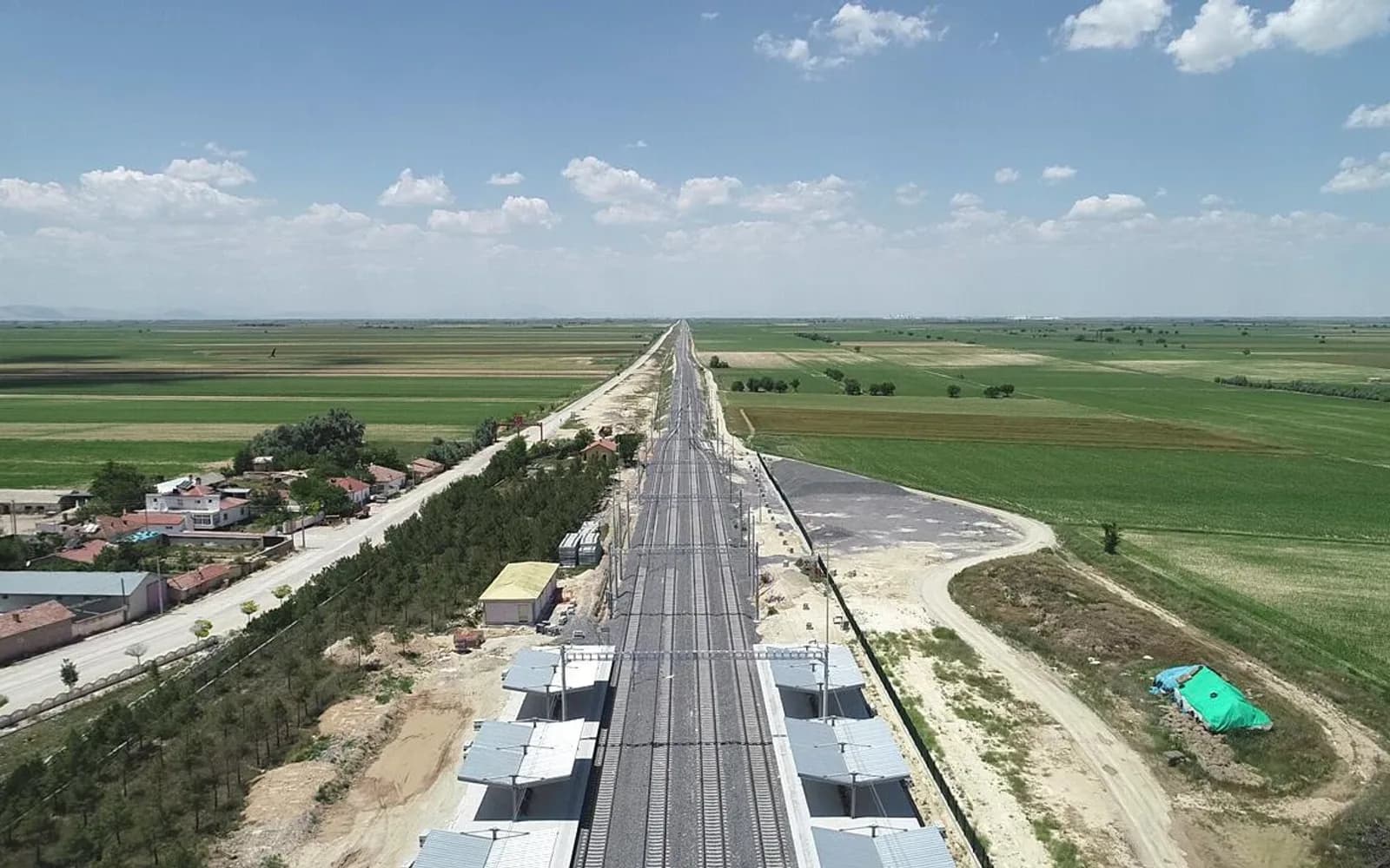 Aerial view of the completed Suduragi-Ayranci high-speed railway line with overhead catenary running through farmland.